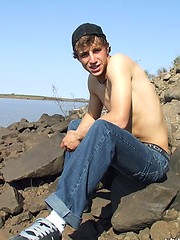 Handsome twink guy posing for the camera outdoors